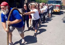 Kevin Fast, billed as a the world's strongest man, led the charge Friday (June 17) as a group tried to move a 42-ton Peterborough fire truck. Kevin is again honourary chair of the Fire Truck Pull For Dementia fundraiser set for September 16, 2016 in the parking lot of the Peterborough Memorial Centre. (Photo: Paul Rellinger / kawarthaNOW)