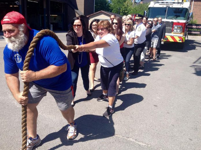 Kevin Fast, billed as a the world's strongest man, led the charge Friday (June 17) as a group tried to move a 42-ton Peterborough fire truck. Kevin is again honourary chair of the Fire Truck Pull For Dementia fundraiser set for September 16, 2016 in the parking lot of the Peterborough Memorial Centre. (Photo: Paul Rellinger / kawarthaNOW)