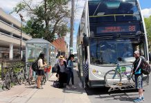 Michael Empey loads his bicycle onto the GO Bus rack at the Simcoe Street Go Bus stop in downtown Peterborough. Empey commutes from Marmara to Hamilton each week using bike and bus. The new Ontario Climate Change Action Plan proposes to include support for commuter cycling infrastructure. (Photo: Karen Halley, GreenUp)