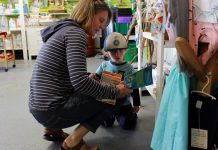 Michael Harrald browses through the children's section at the GreenUP Store with her son Tobin who reads through the children's book, "Nurdle The Turtle – Lessons in Litter", written by local author, Rochelle Archibald. Harrald explains that she enjoys shopping at the GreenUP Store for its unique local gift choices and for many practical every day items such as lunch containers and cleaning products. (Photo: Karen Halley, GreenUP)