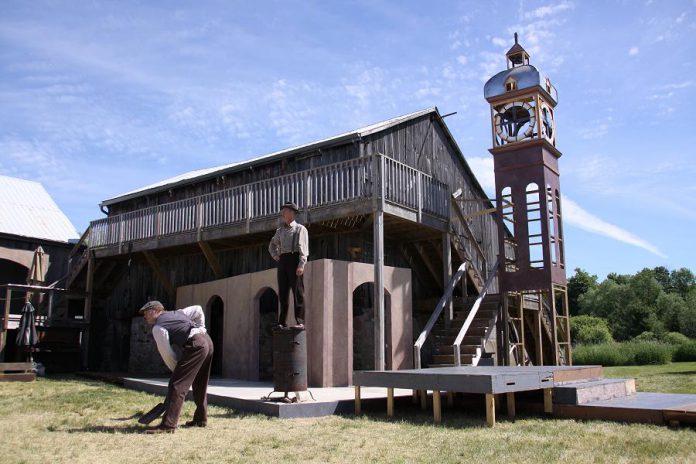 Part of the set for 4th Line Theatre's original production The Hero of Hunter Street at the Winslow Farm in Millbrook, with a reproduction of the downtown Peterborough clock tower in the background (photo: Jeannine Taylor / kawarthaNOW)