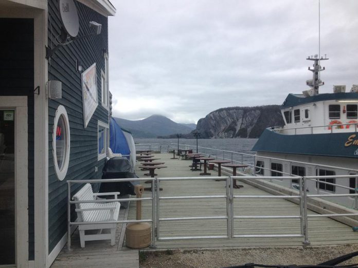 Mayhemingways in Newfoundland: the view from the deck at The Cat Stop, a bar in Norris Point, Newfoundland. The boat on the right is the water taxi that takes folks between Norris Point and Woody Point.