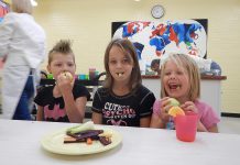 Students at Prince of Wales School (Mariah Dalzell, Paige Dalzell, and Sabrina Dalzell) enjoy a healthy snack of local food (photo: Peterborough Public Health)