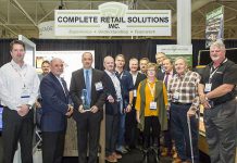 Complete Retail Solutions accepting the Best of Show award from the Canadian Federation of Independent Grocers (CFIG) at Grocery Innovations Canada. Left to right: Dan McMurray (Executive VP Southern CaseArts), Mike Guy (Woodarts), Thomas A. Barlow (President & CEO CFIG), Greg Butler (President, CRS/Pan-Oston), Bennet Foster (President, TechniLite Systems), Stephen Philpott (President, Woodarts), Glen Bonner (VP sales, CRS/Pan-Oston), Phil Golsby (sales, Pan-Oston), Donna O'Brien (VP Sales, Technilite), Dave Powell and Peter Cavin of CFIG, Pete Scanlon (Sales and Marketing CRS/Pan-Oston), and Neil Trineer (VP Sales and marketing Maintech). (Photo courtesy of CRS/Pan-Oston)