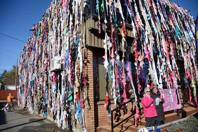 Donna Chamberlain, who alone collected 1,953 bras, with My Left Breast owner Bridget Leslie in front of the Country 105/Energy 99.7 building in downtown Peterborough (photo: Eva Fisher)