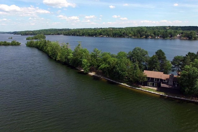 This breathtaking property has a home, a boathouse, 2 outbuildings and 2400 feet of shoreline. (Photo: Scene from Above)