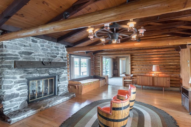 The great room features a stone fireplace and cathedral ceilings. (Photo: Peterborough Fine Homes Photography)