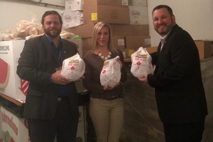 Ashlee Aitken of Kawartha Food Share with Barry McNair (left) and Bryan Buchanan (right) of Shorelines at Kawartha Downs (photo: Kawartha Food Share)