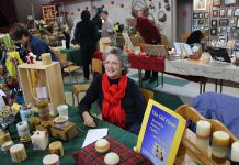 Melodie McCullough of This Old Flame Beeswax Candles displays decorative and traditional beeswax candles, hand crafted in Peterborough at the 2015 Artisan Show and Sale. McCullough is also participating in this year's fundraiser for Jamaican Self-Help, which takes place November 12 and 13 at Mark Street United Church in Peterborough. (Photo: Jamaican Self-Help)