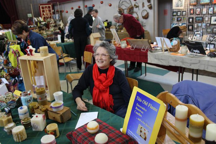 Melodie McCullough of This Old Flame Beeswax Candles displays decorative and traditional beeswax candles, hand crafted in Peterborough at the 2015 Artisan Show and Sale. McCullough is also participating in this year's fundraiser for Jamaican Self-Help, which takes place November 12 and 13 at Mark Street United Church in Peterborough. (Photo: Jamaican Self-Help)