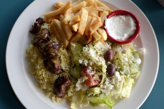 Souvlaki is a popular menu item. It is served with Greek salad and fries made from local potatoes. (Photo: Eva Fisher)