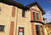 The bricks of the soon-to-open Publican House Restaurant in downtown Peterborough are being repainted by The Brick Painters (photo: Eva Fisher / kawarthaNOW)