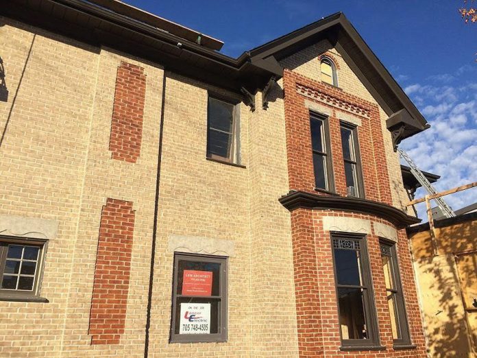 The bricks of the soon-to-open Publican House Restaurant in downtown Peterborough are being repainted by The Brick Painters (photo: Eva Fisher / kawarthaNOW)