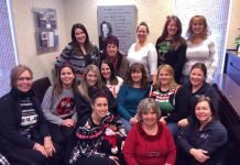 The team at Cornerstone Family Dentistry gather for a group photo in front of the new canvas tribute to founder Dr. Judith Buys, who died in a tragic accident in August 2016 (photo: Cornerstone Family Dentistry / Facebook)