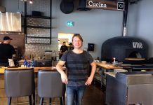 Co-owner and Manager Matt Choma stands in front of the wood-fired pizza oven in the restaurant section of One Fine Food, a new Italian-inspired restaurant and marketplace opening this week in Peterborough. (Photo: Eva Fisher / kawarthaNOW)