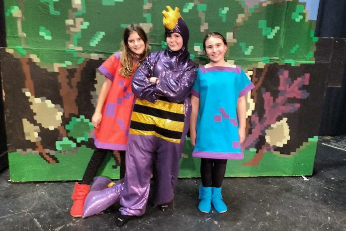 Katherine Mason as Widget, Samuelle Weatherdon as Mortimer the Dragon, and Emily Keller as Hairytoes at a dress rehearsal for "The Reluctant Dragon", the Peterborough Theatre Guild's annual holiday family play which opens on December 6 (photo: Sam Tweedle / kawarthaNOW)