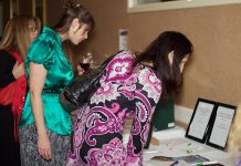 WBN members browse silent auction items at the 2015 Holiday Gala and Auction Fundraiser. For this year's gala, the organization has raised it fundraising goal to $20,000 in response to the urgent need in the community to support women and their children escaping situations of violence and abuse.