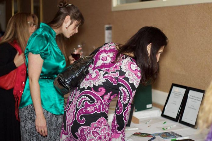 WBN members browse silent auction items at the 2015 Holiday Gala and Auction Fundraiser. For this year's gala, the organization has raised it fundraising goal to $20,000 in response to the urgent need in the community to support women and their children escaping situations of violence and abuse.