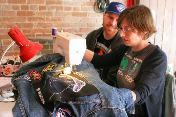 Volunteer fixer Kathryn Bahun helps an attendee of Repair Café Peterborough sew a patch on his jean jacket. Repair Café sewists can help you patch, stitch, and fix all sorts of clothing and apparel items, for free! Fixing rips and tears and updating with patches and custom embellishments helps clothing last longer, prevents un-necessary consumption of new items, and keeps clothes out of landfills.