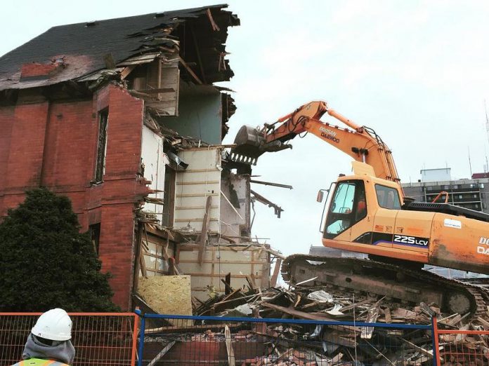 Dave Rogers of Relic had hoped to recover the roof rafters from this building at Alymer and Simcoe Street in Peterborough, which was torn down last week. He had earlier offered to build reading tables from the reclaimed lumber for the new library space. Instead, the wood was destroyed during the demolition. (Photo: Dave Rogers / Instagram)