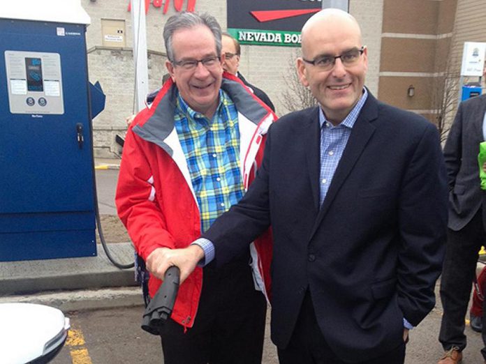 Peterborough MPP Jeaf Leal and Ontario Minister of Transportation Steven Del Duca demonstrate the electric vehicle charging station at Lansdowne Place Mall. The mall is one of seven locations in the City and County of Peterborough offering electric vehicle charging, which is free for the first year of operation. (Photo: Paul Rellinger / kawarthaNOW)