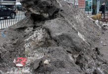 A paper coffee cup and other littered items emerge from a snowbank at the corner of Charlotte and Aylmer Streets in downtown Peterborough during the 2017 January thaw. Take steps now to reduce roadside garbage and litter that accumulates throughout the winter to minimize the unsightly mess that appears each spring. (Photo: GreenUP)