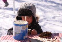 A child coats a pine cone with lard at the bird-feeding station at Ecology Park, which has engaged more than 10,000 children in educational programs over the past 25 years. Peterborough GreenUP has embarked on an ambitious five-year plan to fund raise $440,000 to improve the park and expand programming. (Photo: Jeannine Taylor / kawarthaNOW)