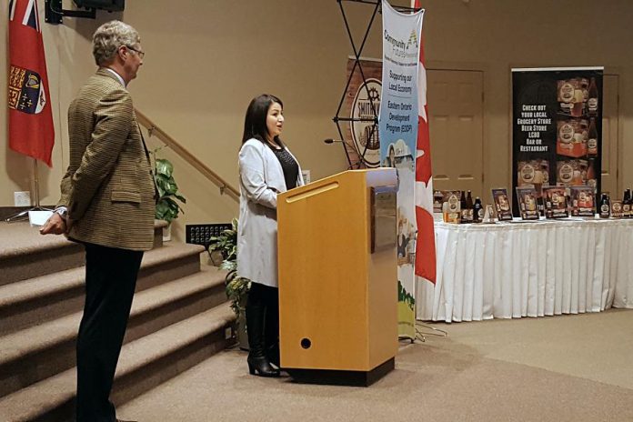 As Community Futures Peterborough member Gord James looks on, Peterborough-Kawartha MP Maryam Monsef speaks at a March 2nd showcase highlighting successes under the Eastern Ontario Development Program, a federal grant program to advance economic development in rural eastern Ontario. In the Peterborough area, Community Futures Peterborough administers the program that has benefited 557 organizations and businesses over the past 14 years. (Photo: Jeannine Taylor / kawarthaNOW)