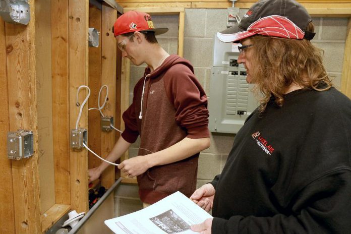 St. Stephen Catholic Secondary School student Zack Dingwall, 17, who is enrolled in the electrician course as part of the Ontario Youth Apprenticeship Program at Durham College, takes instruction from teacher Jeff Van Moosdyk at the Whitby Trade Centre.