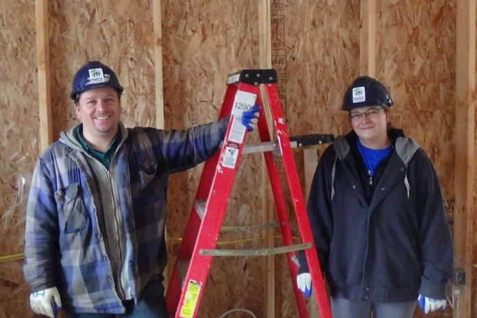 Joshua and Natasha (Bandi) Clark on the build site of their soon-to-be-home in Warsaw. The couple, who originally met at YES Shelter for Youth and Families in Peterborough when they were both homeless youth, now have two children and are looking forward to having their own home. (Photo courtesy of Habitat for Humanity Peterborough & Kawartha Region)