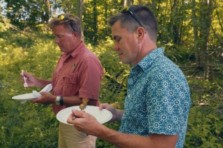 Greg Elmhirst (right) tries out the fish fry shore lunch available with new guided fishing experiences. (Photo: Justen Soule)