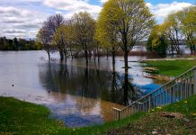 Little Lake rising above the retaining walls and flooding the parking lot at Ashburnham Lock 20 at Beavermead Park in Peterborough. Over 100mm of rain has already fallen in Peterborough since the beginning of May. (Photo: Bruce Head / kawarthaNOW)