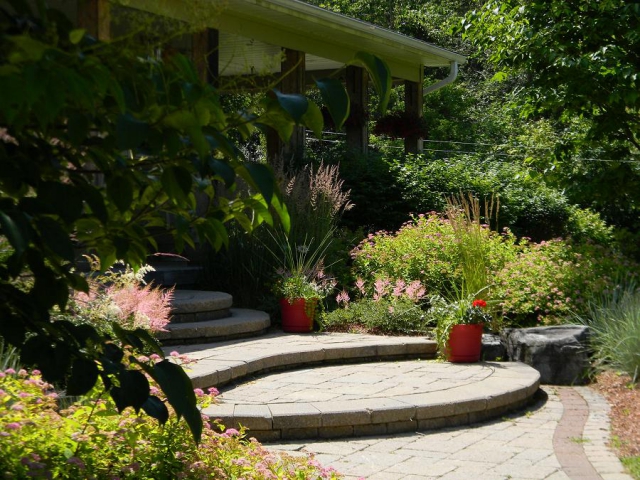 Beautifully curved garden steps traverse through a stunning low-maintenance garden featuring ornamental grasses. (Photo: Cavan Hills Landscaping)