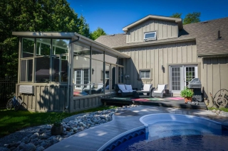 Sunrooms allow you to bring the beauty of your backyard indoors. This family can entertain poolside year round. (Photo: Lifestyle Home Products)