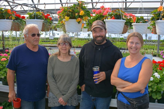Gary McMullen tends the greenhouses with niece Lynn, son Mark, and daughter-in-law Karin. (Photo: Eva Fisher / kawarthaNOW)