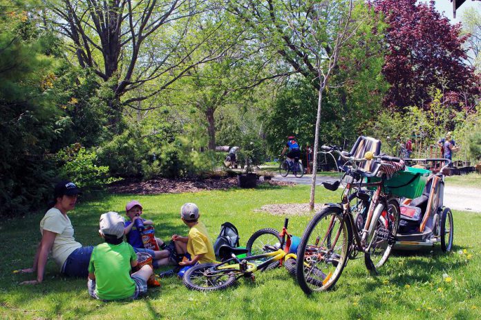 Family and friends enjoy a rest and a snack at GreenUP Ecology Park, along the Trans Canada Trail in East City, Peterborough. Summer is the perfect time to maximize outdoor time, which is essential for healthy childhood development and is beneficial for the physical and emotional health of all ages. (Photo: GreenUP)