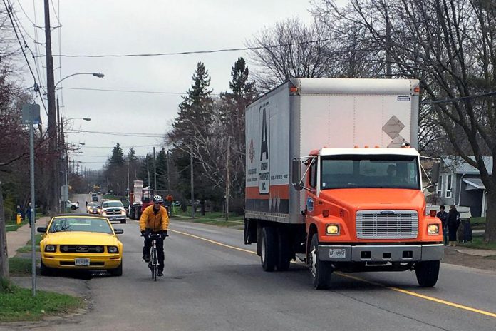 A cyclist passes a parked car on River Road in Peterborough, while the driver of a truck gives ample space when passing the cyclist. Giving a minimum of one metre of space when passing a cyclist is the law. The one-metre cushion is designed to keep everyone safe on our roads. (Photo: Lindsay Stroud)