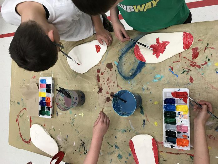 Students from Peterborough's St. Paul and Immaculate Conception Catholic Elementary Schools working on "Canada Walking Forward", an art exhibit of 150 clay footprints of the students' own feet decorated to answer the question "What does Canada mean to you?". The exhibit is one of four student art exhibits that will be on display during Peterborough's four-day Canada 150 celebration from June 29 to July 2. (Photo: Canada 150th Committee)