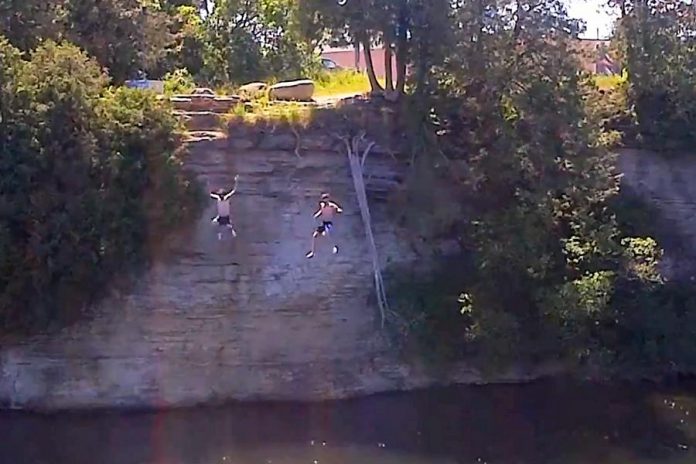 Two boys jumping off of a cliff in Fenelon Falls. 15-year-old boy Harley Broome of Fenelon Falls drowned Saturday afternoon after swimming with friends on the Sturgeon Lake side of the Fenelon Falls locks. (Photo: xorozzzi / YouTube)