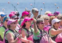 Breast cancer survivor and festival co-chair Michelle Thornton (second from left) during the annual flower ceremony, remembering those who have lost their battle with the disease, at Peterborough's Dragon Boat Festival on June 10. (Photo: Linda McIlwain / kawarthaNOW)