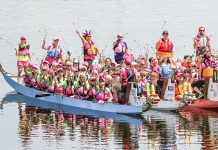 Paddlers at the 2015 Peterborough's Dragon Boat Festival hold their flowers prior to the Carnation Ceremony, an annual tradition to both remember and honour those who have lost their battle with breast cancer. The Carnation Ceremony originates from a 1996 dragon boat race in Vancouver.