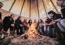 Students sit in a tipi on Symons Campus at Trent University as they listen to a professor. Trent University has consolidated and renamed its indigenous studies program as the Chanie Wenjack School for Indigenous Studies, in honour of the nine-year-old Anishinaabe boy who died from exposure when trying to get home after running away from a residential school in Kenora in 1966. (Photo: Trent University)