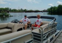 Moe Grant and Lloyd Graham of Pedal 'n' Paddle in the pontoon boat they've added to their fleet of canoe, kayak, bicycle, and pedal boat rentals at The Boat House at Millennium Park.