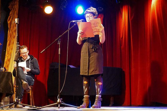 Grown Ups Read Things They Wrote as Kids host Dan Misener listens as a reader in Montreal shares something she wrote as a child. If you have childhood or teenage writing you'd like to share on stage, you can sign up for the September 17th show at Market Hall Performing Arts Centre in Peterborough. (Photo: Jenna Zuschlag Misener)