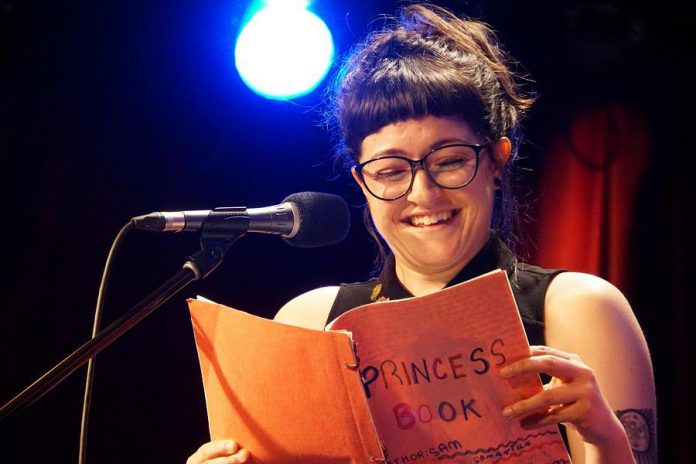 A reader at a Montreal show with her childhood "Princess Book". At Grown Ups Read Things They Wrote as Kids, participants stand in front of an audience and read from their childhood and teenage journals, stories, poetry, and more.  (Photo: Jenna Zuschlag Misener)