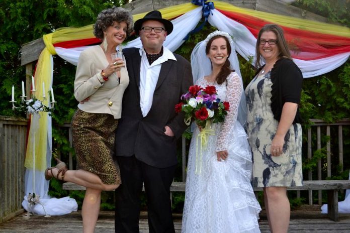 "Wedding guests" Sam Tweedle and Michelle Foster (right) with bride Shannon McGee (Shannon McCracken) and mother of the bride Flossie McGee (Anna Black) in Globus Theatre's unique dinner theatre comedy "Raising the Barn" at Lakeview Arts Barn in Bobcaygeon until August 5th. (Photo: Shelby Camman)