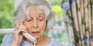 Elderly woman responding to phone scam