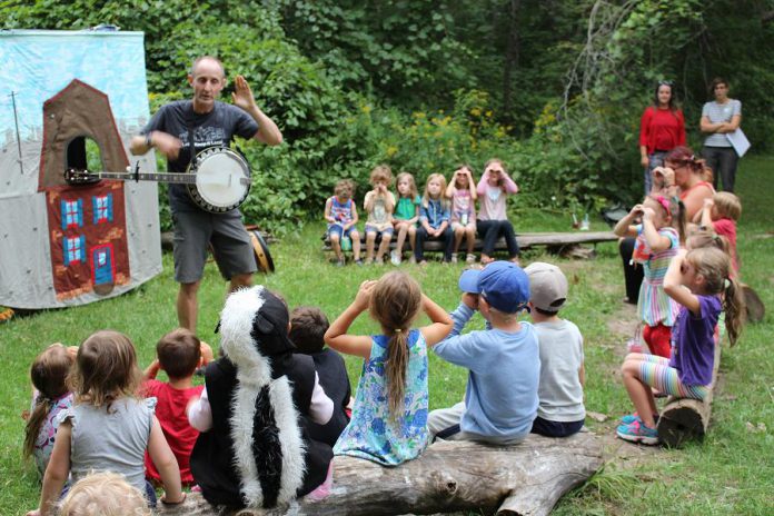 Children enjoy a performance from The Paddling Puppeteer at last year's GreenUP Ecology Park Family Night. This year, join GreenUP for a 25th Birthday Celebration and Family Night on Thursday, August 24th at Ecology Park at 1899 Ashburnham Drive in Peterborough for stream study, music, nature crafts, lantern walk, bike decorating, birthday cake, and more. (Photo: GreenUP)