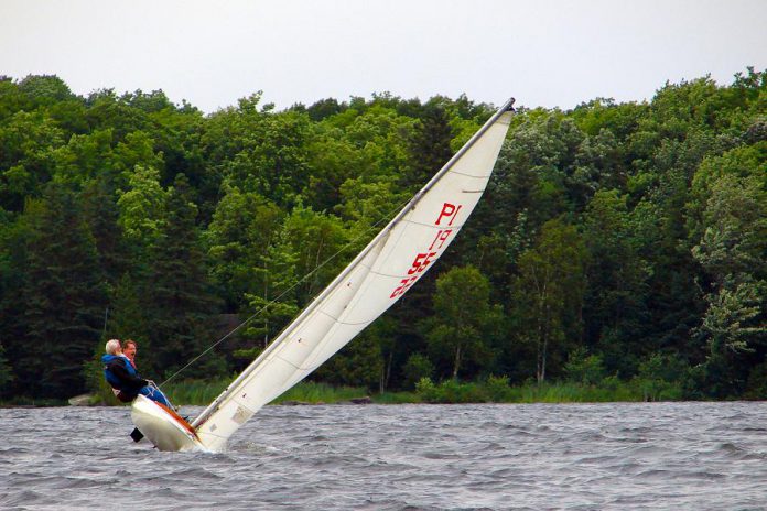 It's common to see M Scow sailors, usually a skipper and one crew, leaning over the side to provide ballast when the boats are in full sail. (Photo: Joe Bowland)