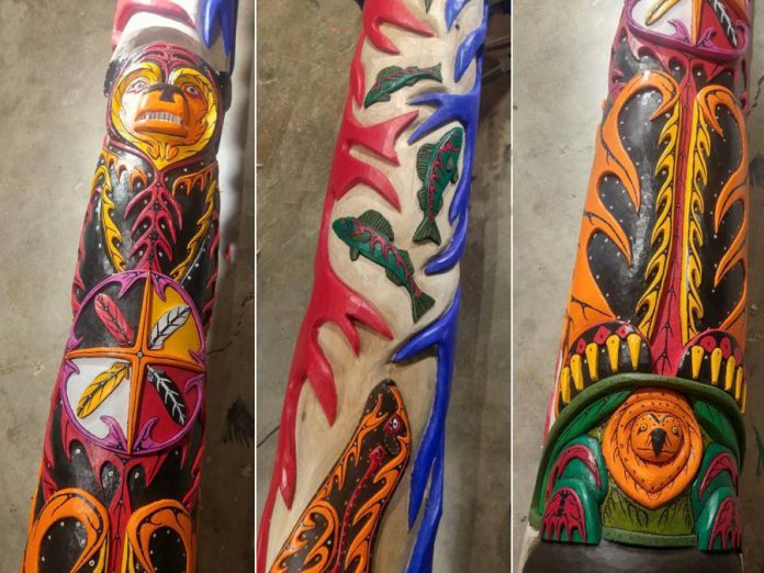 The Unity Pole is painted in the woodland cultural style, with vibrant colours and distinct lines.
